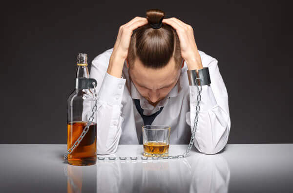 drunk man chained to the bottle